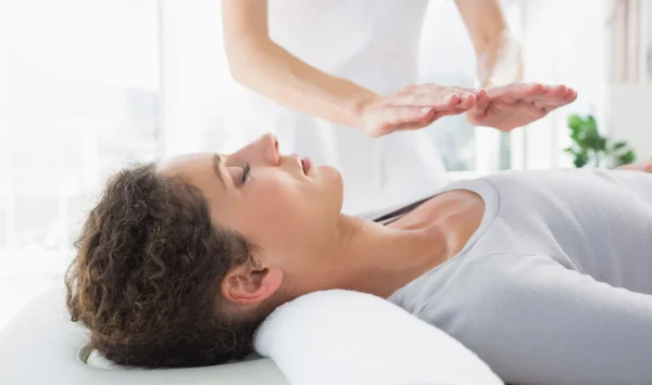 Woman-having-reiki-treatment-Laying-of-hands-of-person-Japanese-alternative-medicine.jpg-600x355